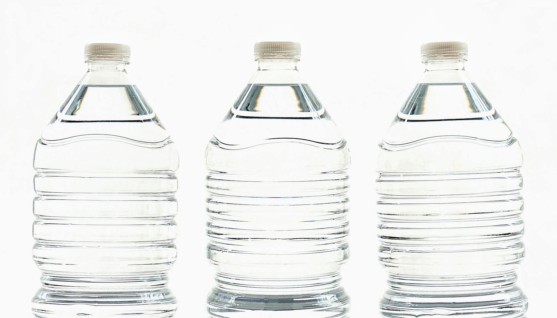 three clear water bottles